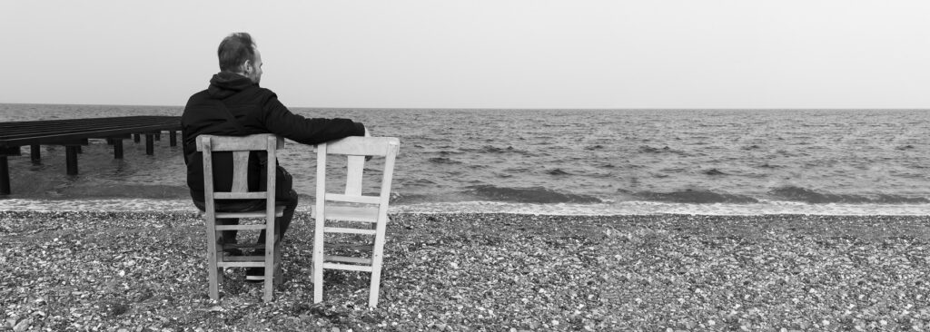 lonely,man,sitting,on,chair,and,watching,distant,sea.,loneliness